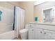 Bathroom featuring a combined tub and shower, white vanity, toilet, and a large mirror at 14624 Via Sorrento Dr # 6206, Charlotte, NC 28277