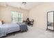 Bright bedroom featuring a large window, neutral paint, carpeted floors, and a ceiling fan at 14624 Via Sorrento Dr # 6206, Charlotte, NC 28277