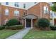 Inviting brick building entrance features well-manicured landscaping and covered entryway with ample natural light at 14624 Via Sorrento Dr # 6206, Charlotte, NC 28277