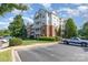 Apartment building with brick and white siding, balconies, landscaping, and a parking area at 14624 Via Sorrento Dr # 6206, Charlotte, NC 28277