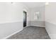 Bright hallway features neutral paint, carpet, and an exterior window for natural light at 14624 Via Sorrento Dr # 6206, Charlotte, NC 28277