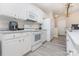 Functional kitchen with white appliances, ample countertop space, and modern flooring at 14624 Via Sorrento Dr # 6206, Charlotte, NC 28277