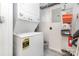 Efficient laundry area with a stacked washer and dryer, plus shelving for extra storage at 14624 Via Sorrento Dr # 6206, Charlotte, NC 28277