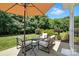 Backyard with a patio and comfortable seating surrounded by lush greenery at 15508 Normans Landing Dr, Charlotte, NC 28273