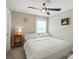 Cozy bedroom features a ceiling fan, soft carpet, and natural light at 15508 Normans Landing Dr, Charlotte, NC 28273