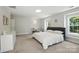 Bright, spacious primary bedroom with plush carpeting, many windows, and neutral decor at 15508 Normans Landing Dr, Charlotte, NC 28273
