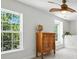 Bedroom with bright windows, ceiling fan, and vintage dresser at 15508 Normans Landing Dr, Charlotte, NC 28273