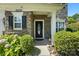 Inviting front entrance with stone accents, decorative shrubbery, and a stylish front door, showcasing curb appeal at 15508 Normans Landing Dr, Charlotte, NC 28273