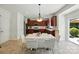 Bright kitchen with modern lighting, stainless steel appliances, and dark wood cabinetry at 15508 Normans Landing Dr, Charlotte, NC 28273