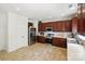 Modern kitchen with stainless steel appliances, cherry cabinets and light countertops at 15508 Normans Landing Dr, Charlotte, NC 28273