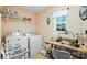 Laundry room with modern washer, dryer, and sewing machine at 15508 Normans Landing Dr, Charlotte, NC 28273