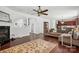 Spacious living room features hardwood floors, a cozy fireplace, and a stylish ceiling fan at 15508 Normans Landing Dr, Charlotte, NC 28273