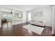 Bright living room featuring hardwood floors, a white couch, and a neutral rug creating a welcoming space at 15508 Normans Landing Dr, Charlotte, NC 28273