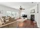 Spacious living area features a fireplace, large windows, and a ceiling fan, providing ample natural light at 15508 Normans Landing Dr, Charlotte, NC 28273