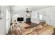 Open-concept living room with hardwood floors, a fireplace, and a comfortable couch, perfect for relaxation at 15508 Normans Landing Dr, Charlotte, NC 28273