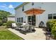 Cozy patio with outdoor seating and umbrella, perfect for entertaining next to the house at 15508 Normans Landing Dr, Charlotte, NC 28273