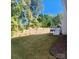 Backyard showcasing a deck, landscaped hillside and a spacious, well-maintained lawn at 15818 Sparrowridge Ct, Charlotte, NC 28278