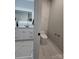 Elegant half-bathroom with marble floors, a vessel sink, and a modern toilet at 15818 Sparrowridge Ct, Charlotte, NC 28278