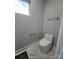 Clean powder room featuring a modern toilet and white tiled floor at 15818 Sparrowridge Ct, Charlotte, NC 28278