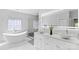 Luxurious bathroom featuring a freestanding tub, walk-in shower, and double marble vessel sinks at 15818 Sparrowridge Ct, Charlotte, NC 28278