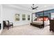 Bright bedroom featuring large windows, neutral carpet, a dark wood four-poster bed, and modern decor at 15818 Sparrowridge Ct, Charlotte, NC 28278