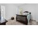 Cozy bedroom featuring a wood bed frame and shuttered windows at 15818 Sparrowridge Ct, Charlotte, NC 28278