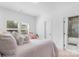 Bright bedroom with a pink bedspread and direct bathroom access at 15818 Sparrowridge Ct, Charlotte, NC 28278