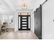 Welcoming entryway featuring a modern front door, barn door, and stylish lighting at 15818 Sparrowridge Ct, Charlotte, NC 28278