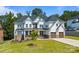 Attractive two-story home featuring a manicured lawn, stone accents, and a two-car garage at 15818 Sparrowridge Ct, Charlotte, NC 28278