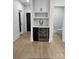Elegant hallway features a wine fridge, a built-in wine rack, and hardwood flooring leading to other rooms at 15818 Sparrowridge Ct, Charlotte, NC 28278