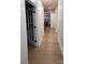 Hallway leading to kitchen with white walls, and hardwood floors at 15818 Sparrowridge Ct, Charlotte, NC 28278