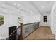 Bright hallway with coffered ceilings, wood floors, and modern light fixture at 15818 Sparrowridge Ct, Charlotte, NC 28278