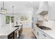 Spacious kitchen featuring an island, stainless steel sink, and a modern gas range at 15818 Sparrowridge Ct, Charlotte, NC 28278
