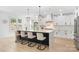 Modern kitchen with a large marble island, stainless steel appliances, and custom lighting at 15818 Sparrowridge Ct, Charlotte, NC 28278