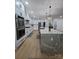 Bright, open kitchen with white cabinets, stainless steel appliances, and a large island with countertop seating at 15818 Sparrowridge Ct, Charlotte, NC 28278