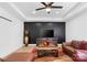Spacious living room with wood accent wall, hardwood floors, and comfortable leather sectional at 15818 Sparrowridge Ct, Charlotte, NC 28278