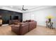 Bright living room features a modern ceiling fan, wood floors, and a stylish black accent wall at 15818 Sparrowridge Ct, Charlotte, NC 28278