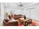 Cozy living room showcasing a leather sectional, rustic wood table, and bright natural light at 15818 Sparrowridge Ct, Charlotte, NC 28278