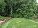 Backyard featuring a lush green lawn and privacy fence, perfect for outdoor activities and relaxation at 1764 Pipers Ridge Nw Cir, Conover, NC 28613
