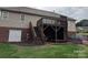 Back of home showing deck, stairs and landscaped backyard with retaining wall at 1764 Pipers Ridge Nw Cir, Conover, NC 28613