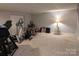 Basement featuring workout equipment, neutral carpet, and access to utility doors at 1764 Pipers Ridge Nw Cir, Conover, NC 28613
