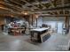 Unfinished basement area featuring exposed wooden beams, concrete floor, and ample storage space at 1764 Pipers Ridge Nw Cir, Conover, NC 28613
