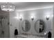 Bright bathroom featuring double sinks, designer mirrors, and stylish lighting fixtures at 1764 Pipers Ridge Nw Cir, Conover, NC 28613