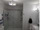 Modern bathroom featuring a marble tile shower, contemporary lighting, and sleek fixtures at 1764 Pipers Ridge Nw Cir, Conover, NC 28613