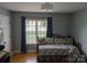 Bright bedroom with a large window and hardwood floors, complemented by cozy daybed at 1764 Pipers Ridge Nw Cir, Conover, NC 28613