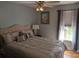 Comfortable bedroom with a large window, neutral tones, and a stylish ceiling fan at 1764 Pipers Ridge Nw Cir, Conover, NC 28613