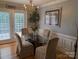 Elegant dining area with modern lighting, hardwood floors, and a view of the backyard at 1764 Pipers Ridge Nw Cir, Conover, NC 28613