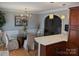 Open dining room featuring modern lighting, hardwood floors, and an arched entryway at 1764 Pipers Ridge Nw Cir, Conover, NC 28613
