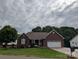 Charming single-story brick home featuring an attached two-car garage and well-maintained landscaping at 1764 Pipers Ridge Nw Cir, Conover, NC 28613