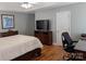 Comfortable main bedroom featuring hardwood floors, a ceiling fan, and plenty of natural light at 1764 Pipers Ridge Nw Cir, Conover, NC 28613